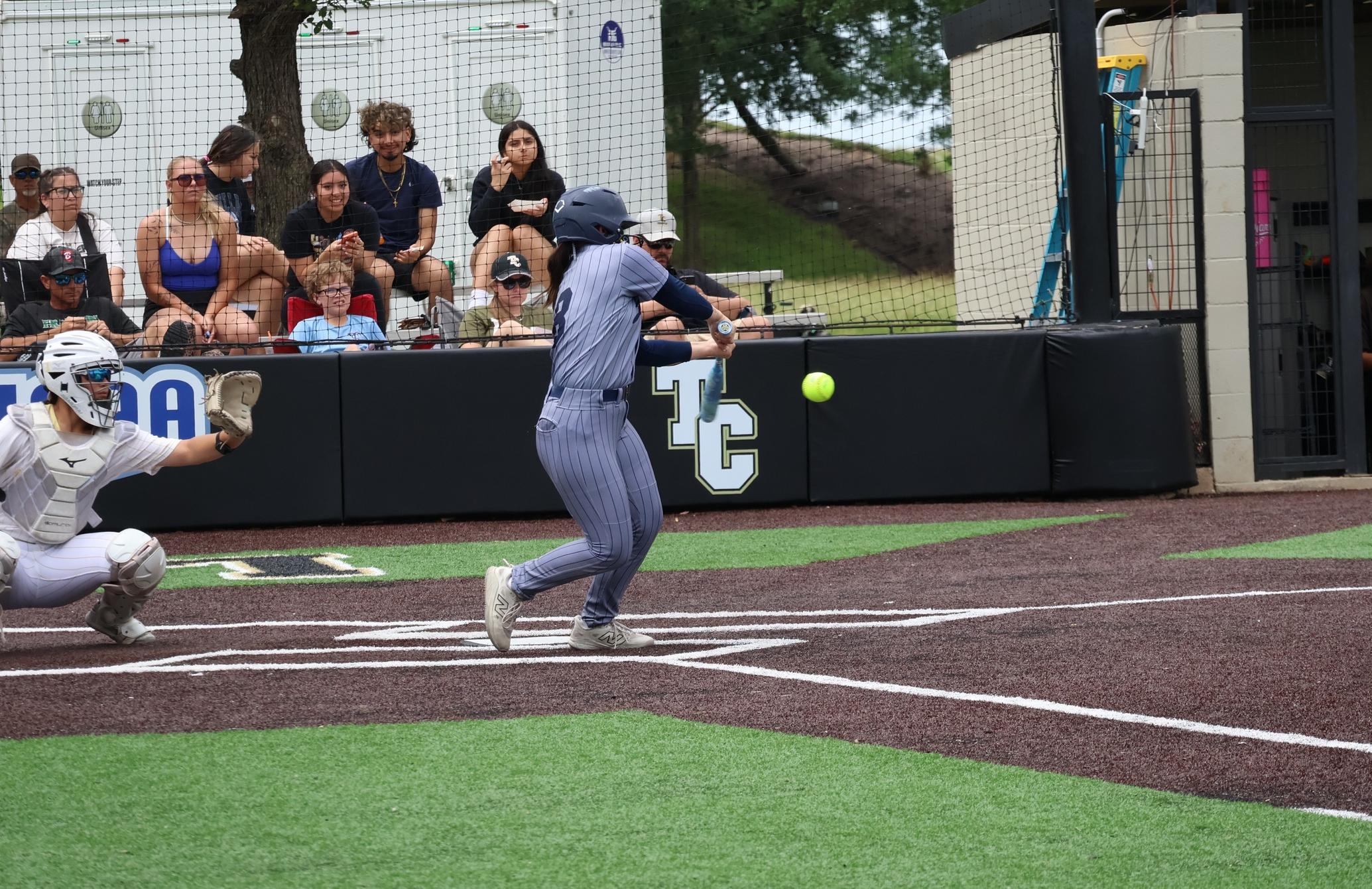 The player in gray hits the ball in the softball game on Friday, May 15.
